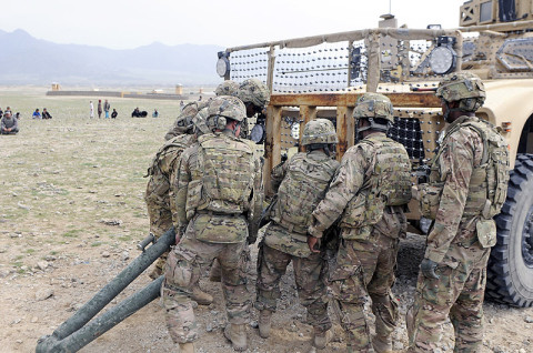 U.S. Army Soldiers from 426th Brigade Support Battalion, 1st Brigade Combat Team, 101st Airborne Division, hook a tow bar to a vehicle for training March 20 at a range outside Forward Operating Base Mehtar Lam, Afghanistan. (U.S. Army photo by Sgt. Jon Heinrich, CT 1-101 Public Affairs)