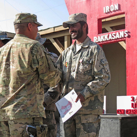 Army Sgt. Luciano Mada, a medic assigned to Headquarters, Headquarters Company, 3rd Battalion, 187th Infantry Regiment, 3rd Brigade Combat Team “Rakkasans,” 101st Airborne Division (Air Assault), shakes hands with an Afghan Border Policeman during their graduation ceremony of his medical course at Forward Operating Base Salerno, Afghanistan. (Courtesy Photo)