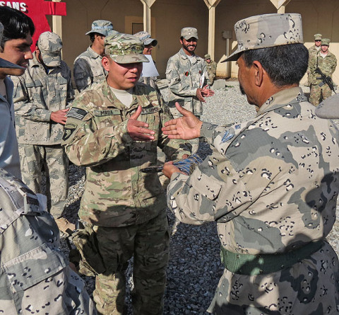 Army Sgt. Luciano Mada, a medic assigned to Headquarters, Headquarters Company, 3rd Battalion, 187th Infantry Regiment, 3rd Brigade Combat Team “Rakkasans,” 101st Airborne Division (Air Assault), shakes hands with an Afghan Border Policeman during their graduation ceremony of his medical course at Forward Operating Base Salerno, Afghanistan. (Courtesy Photo)