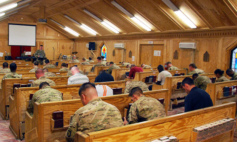 U.S. Army Capt. Erik Alfsen, chaplain, 3rd Battalion, 187th Infantry Regiment, 3rd Brigade Combat Team, 101st Airborne Division (Air Assault), delivers the benediction to parishioners praying during Easter Sunday at Chapel Next at Forward Operating Base Salerno, Afghanistan, March, 31st, 2013. (Courtesy photo) 