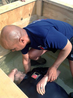 U.S. Army Capt. Scott Norman, chaplain, 1st Squadron, 33rd Cavalry Regiment, 3rd Brigade Combat Team “Rakkasans,” 101st Airborne Division (Air Assault), baptizes a Soldier in water on Good Friday at Camp Clark, Afghanistan, March 31st, 2013. It is a very rare oppurtuity for Soldiers to be baptized while deployed. (Courtesy photo)