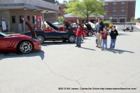 A family looking at the various Corvettes  at the Corvettes on the Cumberland Car Show