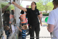 A young man looks at a potential pet as a Animal Control worker checks the id tag