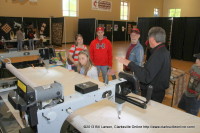 A young lady looks at a quilting machine at Quilts of the Cumberland