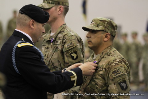 Colonel Valery C. Keaveny, Jr. pins a Purple Heart on Sgt. Matthew Guess