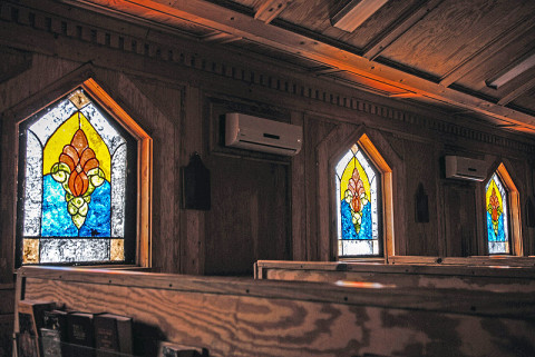 Stained glass windows that were hand-painted by a team of chaplain’s assistants are now on display at the chapel on Forward Operating Base Salerno, Afghanistan. A team of chaplain’s assistants teamed up together to finish the restoration of their chapel after it was badly damaged by an attack on the FOB in the summer of 2012. (U.S. Army photo by Sgt. 1st Class Abram Pinnington, TF 3/101 Public Affairs)