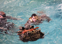 Sgt. Angel Colon, Co. D, 160th SOAR (A), swims with a rucksack during the water survival event for Noncommissioned Officer, and Soldier of the Year Competition, April 2-5 at Fort Campbell, Ky.  (Photo by Staff Sgt. Ricardo Branch, 160th SOAR Public Affairs)