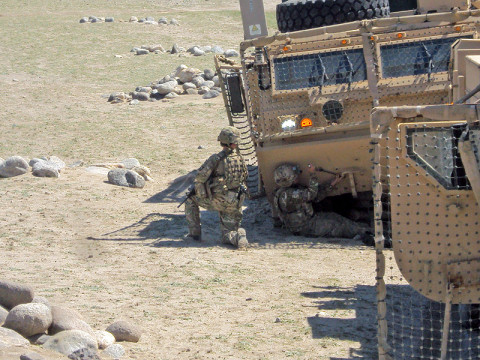 U.S. Army Spc. Peter Brousseau, a member of the Forward Operating Base Fenty Quick Reaction Force and the 426th Brigade Support Battalion, 1st Brigade Combat Team, 101st Airborne Division, removes armor plating from an M1120 HEMTT Load Handling System in order to pull the vehicle back onto the road. (U.S. Army photo by 1st Lt. Lisa Maginot, 426th BSB Unit Public Affairs Representative)