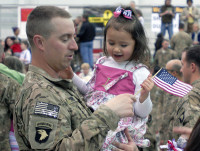 A Soldier from the 3rd Brigade Combat Team “Rakkasans,” 101st Airborne Division (Air Assault) embraces his daughter as he returns from a deployment to Afghanistan and they see each other for the first time in seven months at a welcome home ceremony. The event marked the third group of Rakkasans to return early from the brigade’s current nine month deployment due to the increasing progress of the Afghan National Security Forces in the region. (U.S. Army photo taken by Sgt. Alan Graziano, 3rd Brigade Combat Team, 101st Airborne Division)