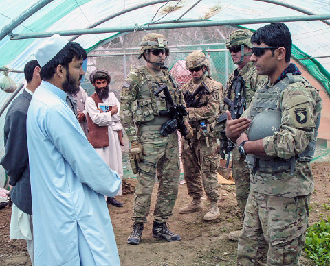 Army Maj. Gregory Motz, the executive officer for the Khowst Province Provincial Reconstruction Team, of the 5-19th Agribusiness Development Team, Indiana National Guard, along with his team, meets with local farmers and area representatives in a green house to discuss various agriculture techniques, in Khowst Province, Afghanistan, March 16, 2013. (U.S. Army Photo by Spc. Brian Smith-Dutton TF 3/101 Public Affairs)