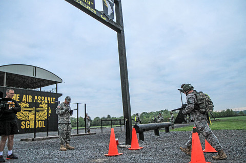 Sgt. 1st Class Greg Robinson, a combat engineer with Company A, 2nd Brigade Special Troops Battalion, 2nd Brigade Combat Team, 101st Airborne Division (Air Assault), pours water over himself moments before finishing the12-mile road march for The Sabalauski Air Assault School at Fort Campbell, April 29. Robinson is the first amputee to graduate the school and says, “A disability is only a disability if you let it hold you down.” (U.S. Army photo by Sgt. Joe Padula, 2nd BCT PAO, 101st Abn. Div.)