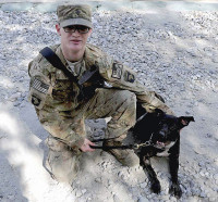 U.S. Army Spc. Matt Kreutzer, a military working dog handler with 1st Brigade Combat Team, 101st Airborne Division, and Sgt. Mimsy, a military working dog, stop for a photo during training at Forward Operating Base Wright, Kunar province, Afghanistan. Mimsy was recently released from quarantine after rescuing Kreutzer from a feral dog during a recent foot patrol. (U.S. Army Photo by Sgt. Shawn Vradenburg, Provincial Reconstruction Team Kunar)