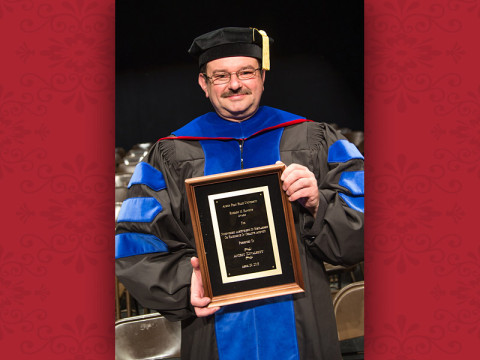 Dr. Andriy Kovalskyy, associate professor of physics, with his Hawkins Award. (Photo by Beth Liggett/APSU)