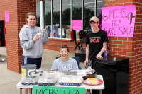 MCHS FCA holds Bake Sale at Hilltop Super Market. (L to R) Sara Jackson, Megan Minor, and Benjamin McKinney.