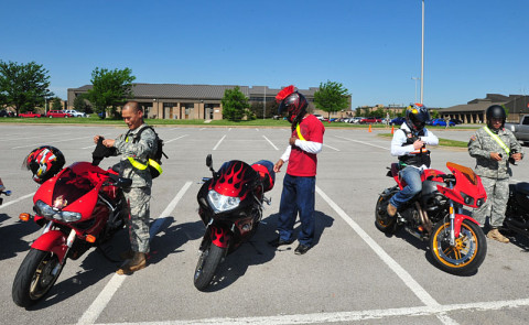 Soldiers with 4th Brigade Combat Team, 101st Airborne Division, begin to put on their personal protective equipment in preparation for inspection, May 15, 2013, as part of the brigade's observance of Motorcycle Safety Awareness Month at Fort Campbell, Ky. (U.S. Army photo by Sgt. Kimberly K. Menzies, 4th Brigade Combat Team Public Affairs)