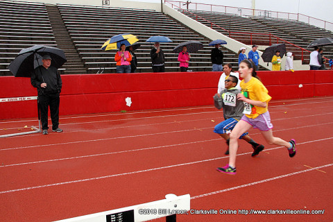 Clarksville Parks and Recreation Director Mark Tummons watches as runners head down the final stretch to the finish line.