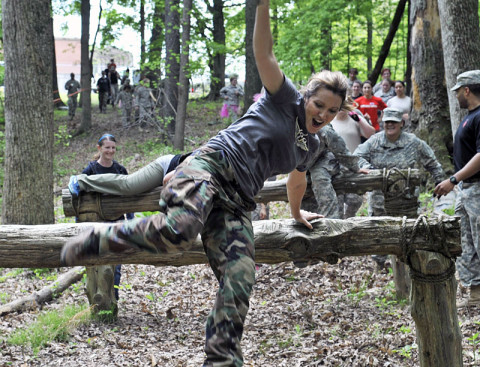 A spouse of a 1st Battalion, 160th Special Operations Aviation Regiment (Airborne) Soldier soars over the gut buster logs during the Pink Platoon event May 2, 2013, at Fort Campbell, Ky. (Photo by Staff Sgt. Rick Branch, 160th SOAR (A) Public Affairs)