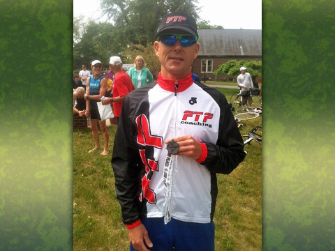 Russ Shemberger of RPM Massage in Clarksville displays the second-place medal he won at the annual Tri Ancilla sprint triathlon held Saturday, May 18th at Ancilla College in Donaldson, IN.