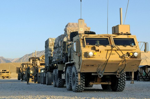 U.S. Soldiers assigned to the 3rd Platoon, 1245th Transportation Company, 1034th Combat Sustainment Support Battalion, move military vehicles as they prepare to leave on their convoy escort team mission at Mazar-e-Sharif, Balkh province, Afghanistan, June 18, 2013.  (U.S. Army photo by Sgt. Sinthia Rosario/Released)