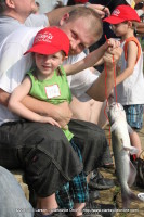 A young man with his first fish of the day