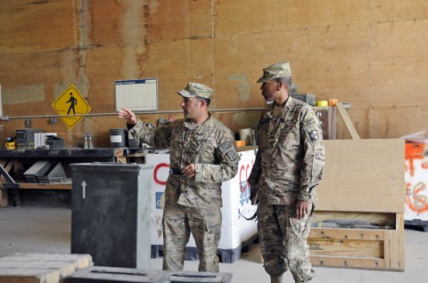 Warrant Officer Alexander A. Arabian a native of Warwick, R.I., and ammunition technician with the 63rd Ordnance Company, briefs Col. Charles R. Hamilton a native of Houston, Texas and commander of Task Force Lifeliner key factors of the operations at the 63rd Ordnance Co. Ammunition Supply Point in support of multiple Afghanistan Regional Commands. (Photo by Sgt. Sinthia Rosario)