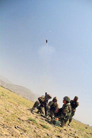 After a week of training, soldiers with the Afghan National Army’s 2nd Khandak, 1st Brigade, 203rd Corps, fire a 60mm Mortar for the first time, during a live fire exercise in Khowst Province, Afghanistan, June 22, 2013. (Photo by Sgt. Justin A. Moeller, 4th Brigade Combat Team Public Affairs)