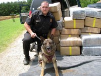 Trooper Brad Atkinson and his K-9 “Charlie” with the marijuana seized Friday morning.