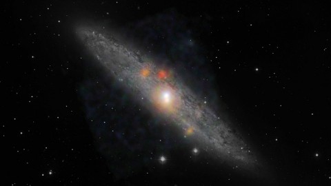 The Sculptor galaxy is seen in a new light, in this composite image from NASA's Nuclear Spectroscopic Telescope Array (NuSTAR) and the European Southern Observatory in Chile. (Image credit: NASA/JPL-Caltech/JHU)