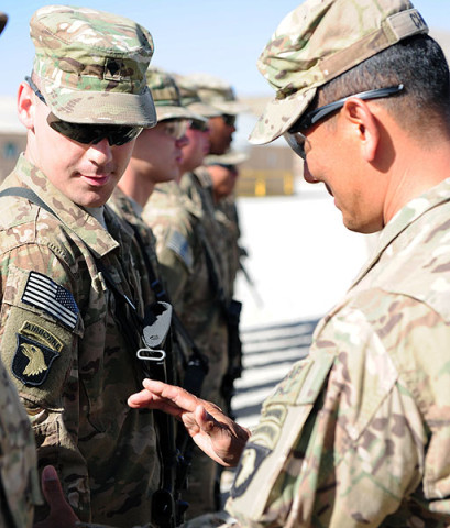 U.S. Army Brig. Gen. Clarence K. Chinn, deputy commanding general for Afghan development south of Kabul, 101st Airborne Division (Air Assault), Combined Joint Task Force 101, presents Spc. Thaddeus Ivory with 4th Battalion, 320th Field Artillery Regiment, 4th Brigade Combat Team, 101st Airborne Division (Air Assault), with the 101st Airborne Division combat patch. (U.S. Army National Guard photo by Spc. Ryan Scott, 129th Mobile Public Affairs Detachment)