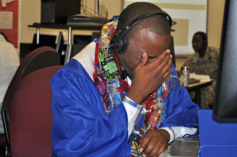 Fort Campbell High School Class of 2013 graduate Michael Clayton III is overcome with emotion as he speaks with his father, 1st Sgt. Michael Clayton Jr., via Skype moments after his high school commencement ceremony. Clayton Jr., who is deployed to Afghanistan with the 2nd Battalion, 327th Infantry Regiment, 1st Brigade Combat Team, 101st Airborne Division, took part in the Division’s “Operation Yellow Ribbon” program. (Photo by Master Sgt. Pete Mayes)