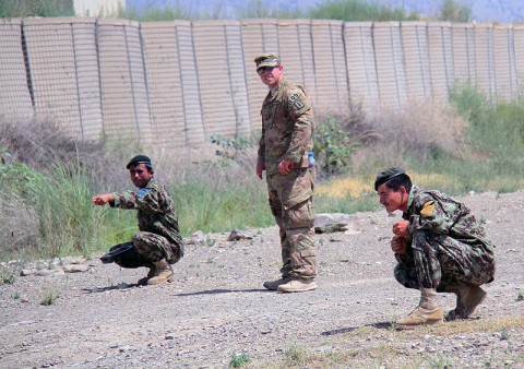 A Soldier with the 4th Khandak, 1st Brigade, 203 Corps, points out to 1st Lt. Cody Faulkner, Platoon leader with the 49th Explosive Ordnance Disposal Company, attached to the 4th Brigade Combat Team, 101st Airborne Division, what he suspects is and improvised explosive device, during a counter improvised explosive device lane, June 20, 2013 at Camp Parsa, Afghanistan. (Photo by U.S. Army Sgt. Justin A. Moeller, 4th Brigade Combat Team Public Affairs)