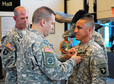 Sgt. Jose L. Orozco is awarded with an Army Commendation Medal for winning the division's Non-Commissioned Officer of the Year competition, June 3rd, at Fort Campbell, Ky. Orozco was pinned during the ceremony by Brig. Gen. Mark R. Stammer, senior acting commander of the 101st and Fort Campbell, and Command Sgt. Maj. Mark F. Herndon (left), rear detachment command sergeant major. Orozco, a Houstonian, serves with Company B., 563rd Aviation Support Battalion, 159th CAB, 101st. (Sgt. David Hodge, 101st Airborne Division)