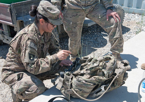 U.S. Army Spc. Bianca Beck, team member, brigade Female Engagement Team, 1st Battalion, 327th Infantry Regiment, 1st Brigade Combat Team, 101st Airborne Division, of Eagle Pass, Texas, secures equipment to her body armor at Forward Operating Base Fenty, Nangarhar Province, Afghanistan, on May 29, 2013. (U.S. Army photo by Sgt. Margaret Taylor, 129th Mobile Public Affairs Detachment)