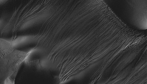 Several types of downhill flow features have been observed on Mars. This image from the High Resolution Imaging Science Experiment (HiRISE) camera on NASA's Mars Reconnaissance Orbiter is an example of a type called "linear gullies." (Image credit: NASA/JPL-Caltech/Univ. of Arizona)