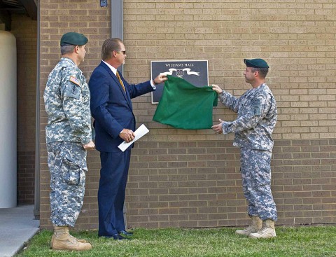 Col. Scott Brower, commander of the 5th Special Forces Group (Airborne), and Lt. Col. Andrew Hanson, commander of 1st Battalion, 5th SFG (A), join Bartley Williams, son of Maj. Charles Q. Williams, a Medal of Honor recipient and former member of the 5th SFG, in unveiling a plaque June 5, during a ceremony naming the battalion’s operations complex as Williams Hall. (Photo by Staff Sgt. Barbara Ospina)