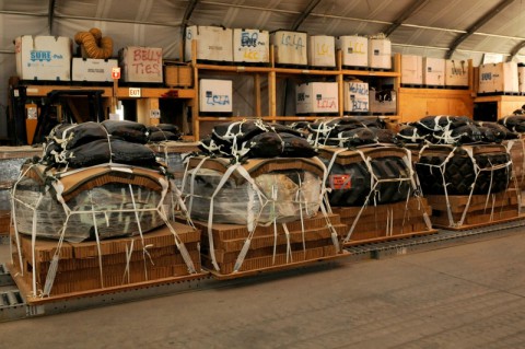 Aerial bundles containing a tire, rigged by the 647th Quartermaster Detachment supporting Task Force Lifeliner, are ready for airdrop mission destined for one of the forward operating bases, June 25, 2013, at Bagram Air Field in Parwan province, Afghanistan.