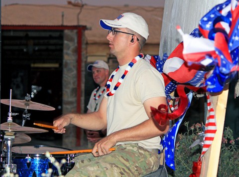 U.S. Army Spc. Stephen Thacker, drummer for the 101st Airborne Division band “Ambush” drums out a groovy beat to a Radio Head song, at Forward Operating Base Sharana, Afghanistan, July 7th, 2013. Soldiers and civilians assigned to the post celebrated Independence Day with carnival games, a barbecue and music. (U.S. Army photo by 1st Lt. Justin Brooks, 2nd Battalion, 15th Field Artillery Regiment)