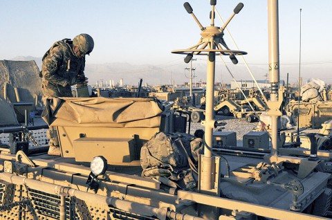 Staff Sgt. Geoffery Rhone, a native of Meridian, Miss., and a soldier with 32nd Transportation Company, Task Force Chain in support of Task Force Lifeliner, loads ammunition into his turret in preparation for a sustainment convoy escort mission, July 8, 2013. The 32nd Transportation Company conducts sustainment and retrograde support operation out of Bagram Air Field, Afghanistan. (U.S. Army photo by Sgt. 1st Class Mary Rose Mittlesteadt, Task Force Lifeliner) Staff Sgt. Geoffery Rhone, a native of Meridian, Miss., and a soldier with 32nd Transportation Company, Task Force Chain in support of Task Force Lifeliner, loads ammunition into his turret in preparation for a sustainment convoy escort mission, July 8, 2013. The 32nd Transportation Company conducts sustainment and retrograde support operation out of Bagram Air Field, Afghanistan. (U.S. Army photo by Sgt. 1st Class Mary Rose Mittlesteadt, Task Force Lifeliner)