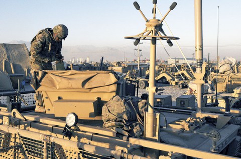 Staff Sgt. Geoffery Rhone, a native of Meridian, Miss., and a soldier with 32nd Transportation Company, Task Force Chain in support of Task Force Lifeliner, loads ammunition into his turret in preparation for a sustainment convoy escort mission, July 8, 2013. The 32nd Transportation Company conducts sustainment and retrograde support operation out of Bagram Air Field, Afghanistan. (U.S. Army photo by Sgt. 1st Class Mary Rose Mittlesteadt, Task Force Lifeliner)