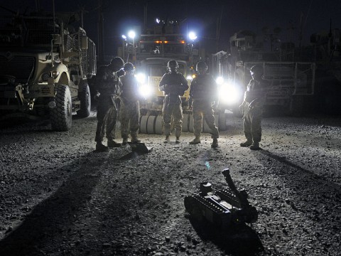 The scout-truck team with 32nd Transportation Company, Task Force Chain in support of Task Force Lifeliner, performs pre-combat checks on their improvised explosive devise reconnaissance robot for a sustainment convoy escort mission, July 8, 2013. The 32nd Transportation Company conducts sustainment and retrograde support operation out of Bagram Air Field, Afghanistan. (U.S. Army photo by Sgt. 1st Class Mary Rose Mittlesteadt, Task Force Lifeliner)