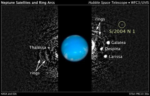 This composite Hubble Space Telescope picture shows the location of a newly discovered moon, designated S/2004 N 1, orbiting the giant planet Neptune, nearly 3 billion miles from Earth. The moon is so small (no more than 12 miles across) and dim, it was missed by NASA's Voyager 2 spacecraft cameras when the probe flew by Neptune in 1989. Several other moons that were discovered by Voyager appear in this 2009 image, along with a circumplanetary structure known as ring arcs.