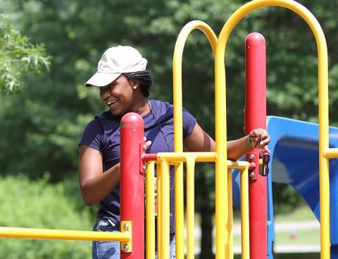 Volunteer camp counselor Pfc. Raven Clark, Headquarters and Headquarters Detachment, 129th Combat Sustainment Support Battalion, 101st Sustainment Brigade, 101st Airborne Division (Air Assault), keeps an eye on campers playing on the playground, July 10th, at Fort Campbell, KY. Volunteers from the brigade spent the entire week at Camp SOS with the children; however, they had to leave their cell phones and cars behind. (U.S. Army photo by Sgt. Leejay Lockhart, 101st Sustainment Brigade Public Affairs)