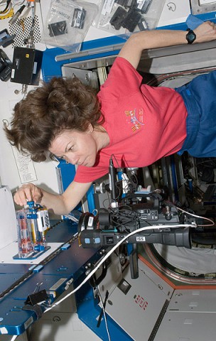 NASA astronaut Catherine (Cady) Coleman, Expedition 26 flight engineer, performs a Capillary Flow Experiment (CFE) Interior Corner Flow 2 (ICF-2) test. The CFE is positioned on a Maintenance Work Area in the Destiny laboratory of the International Space Station. CFE observes the flow of fluid, in particular capillary phenomena, in microgravity.