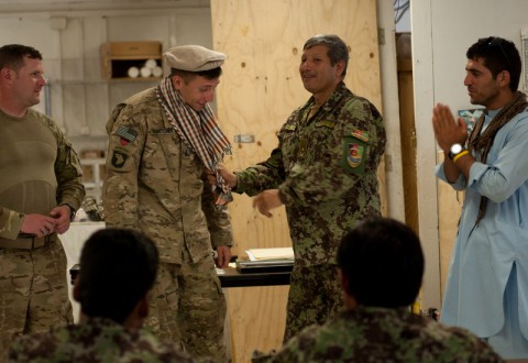 The Afghan National Army deputy commander for the 2nd Kandak, 4th Brigade, gives 1st Lt. Kyle Harnitcheck from Security Forces Advisory and Assistance Team Archangel the gift of a hat and scarf at former Forward Operating Base Shinwar in Nangarhar Province, Afghanistan (Sgt. Margaret Taylor/U.S. Army)