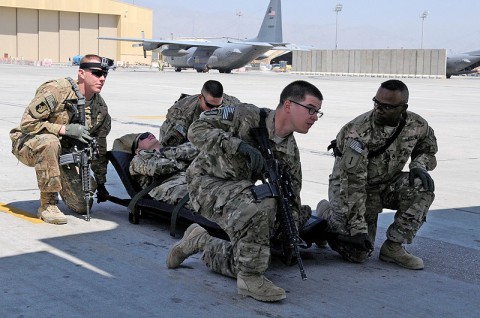 Task Force Lifeliner medics prepare to lift a litter during aeromedical evacuation training with the U.S. Air Force, Aug. 22, 2013 at Bagram Air Field, Parwan province, Afghanistan. During this training the soldiers learn how to safely load and unload patients on and off of a C-130 Hercules aircraft. (U.S. Army photo by Sgt. Sinthia Rosario, Task Force Lifeliner Public Affairs) Task Force Lifeliner medics prepare to lift a litter during aeromedical evacuation training with the U.S. Air Force, Aug. 22, 2013 at Bagram Air Field, Parwan province, Afghanistan. During this training the soldiers learn how to safely load and unload patients on and off of a C-130 Hercules aircraft. (U.S. Army photo by Sgt. Sinthia Rosario, Task Force Lifeliner Public Affairs)