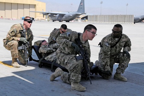 Task Force Lifeliner medics prepare to lift a litter during aeromedical evacuation training with the U.S. Air Force, Aug. 22, 2013 at Bagram Air Field, Parwan province, Afghanistan. During this training the soldiers learn how to safely load and unload patients on and off of a C-130 Hercules aircraft. (U.S. Army photo by Sgt. Sinthia Rosario, Task Force Lifeliner Public Affairs)