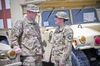 U.S. Army Cpl. Douglas Dalton, medic, and his wife Spc. Megan Dalton, radiology specialist, both with Company C. 801st Brigade Support Battalion, 4th Brigade Combat Team, 101st Airborne Division (Air Assault), talk with each other next to field litter ambulances on Forward Operating Base Salerno, Afghanistan, Aug. 11, 2013. (U.S. Army photo by Sgt. Justin A. Moeller, 4th Brigade Combat Team public affairs)