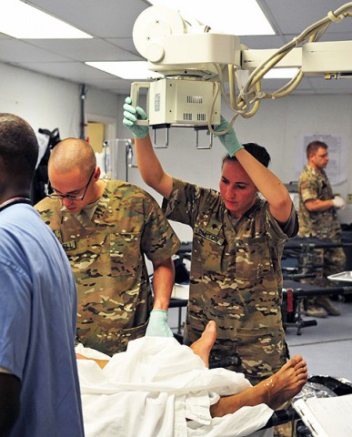 U.S. Army Spc. Megan Dalton, radiology specialist with Company C, 801st Brigade Support Battalion, 4th Brigade Combat Team “Currahee," 101st Airborne Division (Air Assault), utilizes an X-ray machine while working at the Combat Support Hospital on Forward Operating Base Salerno, Afghanistan, July 25, 2013. (U.S. Army photo by Maj. Kamil Sztalkoper, 4th Brigade Combat Team Public Affairs)