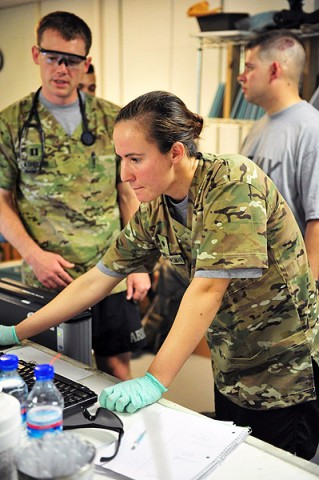 U.S. Army Spc. Megan Dalton, radiology specialist with Company C, 801st Brigade Support Battalion, 4th Brigade Combat Team "Currahee," 101st Airborne Division (Air Assault), checks a computer screen at the Combat Support Hospital on Forward Operating Base Salerno, Afghanistan, July 14, 2013. (U.S. Army photo by Maj. Kamil Sztalkoper, 4th Brigade Combat Team Public Affairs)