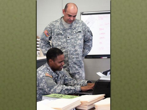 Sgt. Jose Rivera assists Pvt. 1st Class Armando Luna, both automated logistical specialist with Echo Company, 1st Battalion, 506th Infantry Regiment, 4th Brigade Combat Team, 101st Airborne Division, with entering inventory data into a computer program. (Sgt. David Cox, 4th Brigade Combat Team Public Affairs)